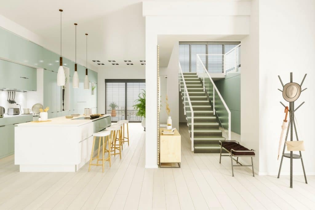 Light green cabinets in a modern white kitchen