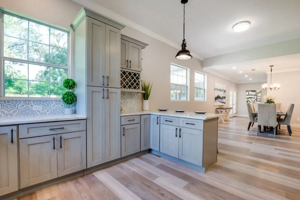 Another view of kitchen with greenery on the countertops.