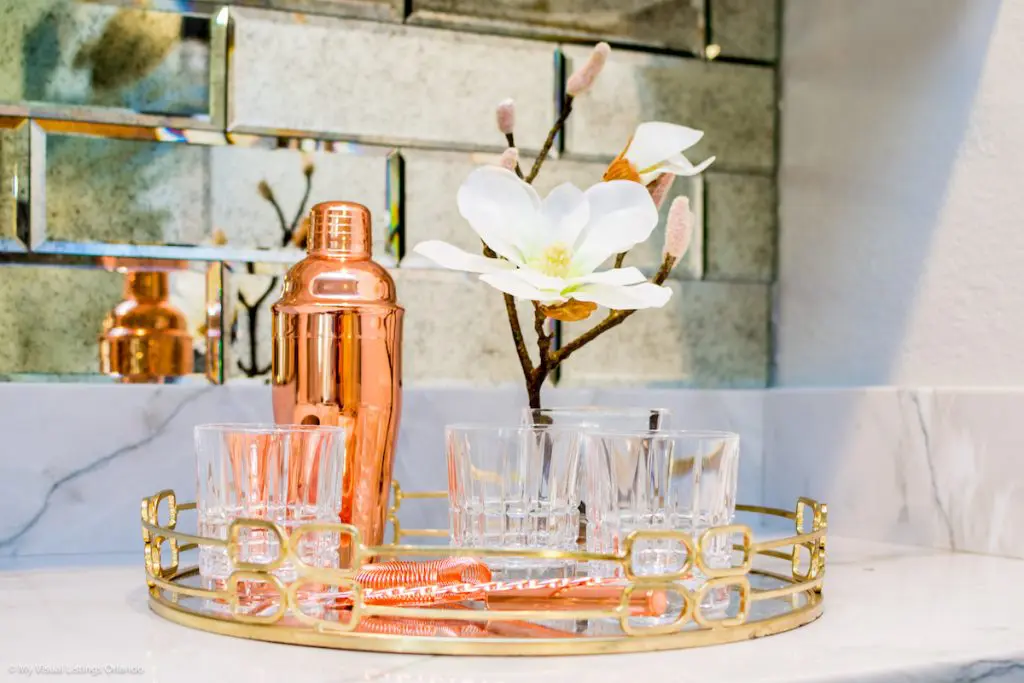 A drink tray with classy glassware and drink accessories.