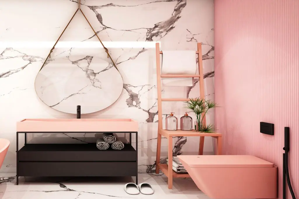 Bathroom with light coral accent wall with marble floors and wall.