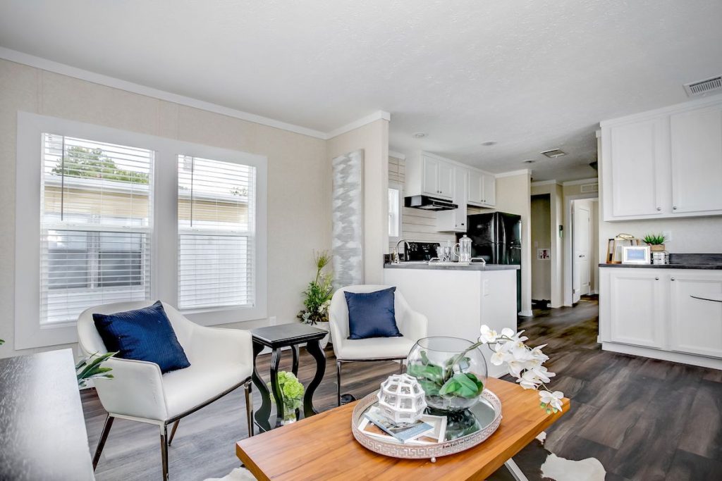 Sitting room area with chairs, throw pillows, and coffee table.