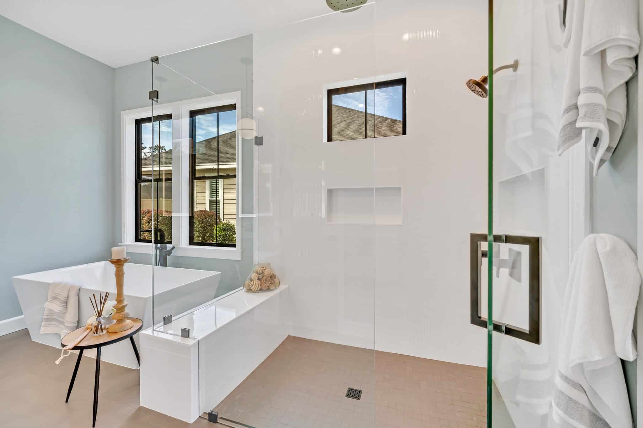 A view of a staged bathroom's walk-in shower and bath tub.